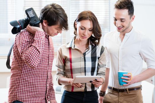 Casual business people having short meeting, woman and two men