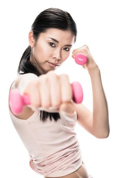 Portrait of young determined woman holding small dumbbells in combat position