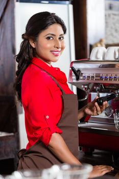 Barista woman making coffee in cafe with machine