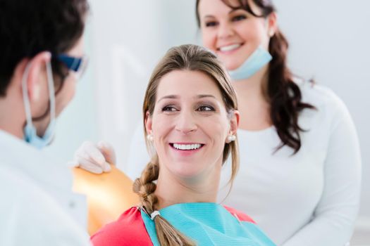 Woman with dentist and nurse smiling