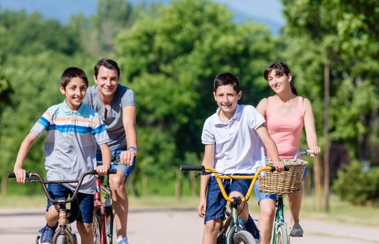 Family of four on bike tour in summer