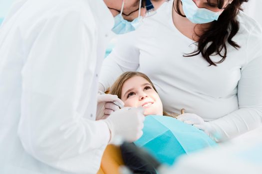 Dentist trearing child in his surgery, there is no need to drill a tooth