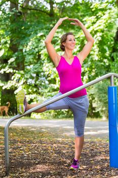 Pregnant woman doing pregnancy yoga on fitness trail