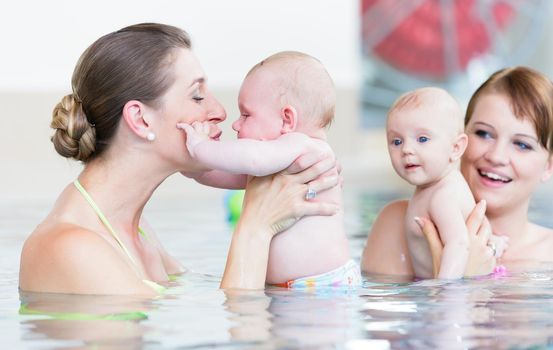 Newborns and their mums at infant swimming course