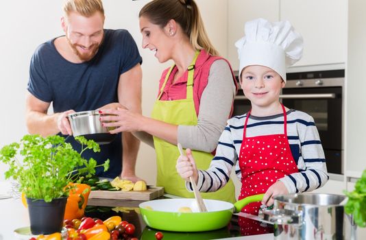 Happy family cooking together in kitchen
