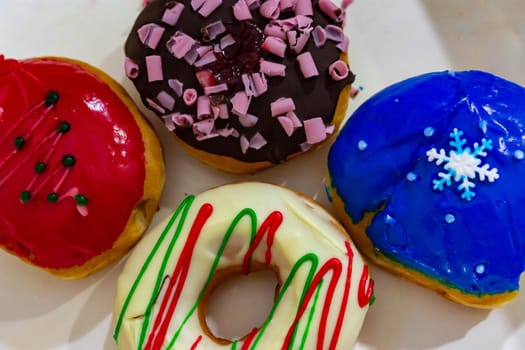 Colorful blue, red, brown and stripe donuts with white background