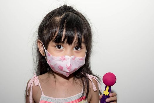 Asian female child wearing a mask to protect against the Corona virus that can spread through the air