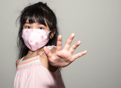 Kids hand to say no against corona virus infection. Blurry image of a female kid showing her hand to symbolize against the spread of corona virus