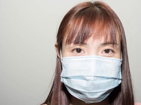 Portrait of a Female asian wearing a mask to protect her against the corona virus.