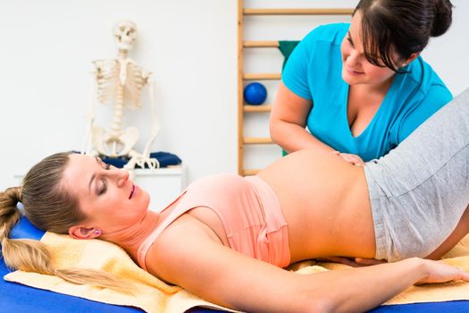 Pregnant woman at physical therapy on couch