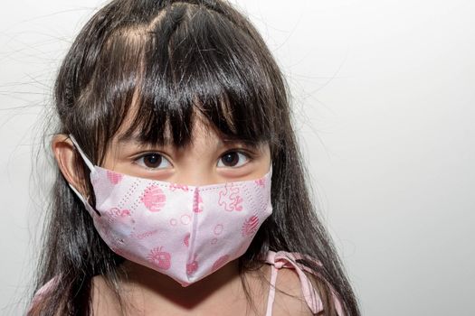 Asian female child wearing a mask to protect against the Corona virus that can spread through the air