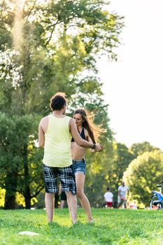 Woman and man dancing in park outdoors