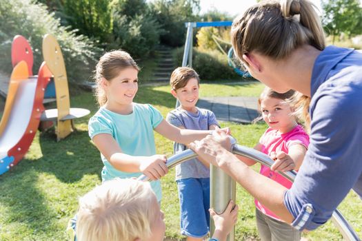 Family having fun at adventure playground in park