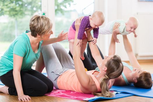 Women and their babies in mother-child gymnastic course together