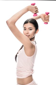 Portrait of fit Asian woman exercising with two small dumbbells against white background