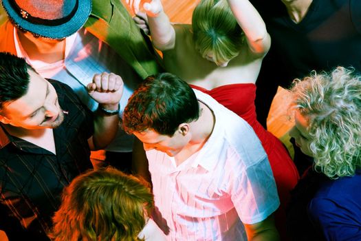 Crowd of people dancing in a disco club having a great party