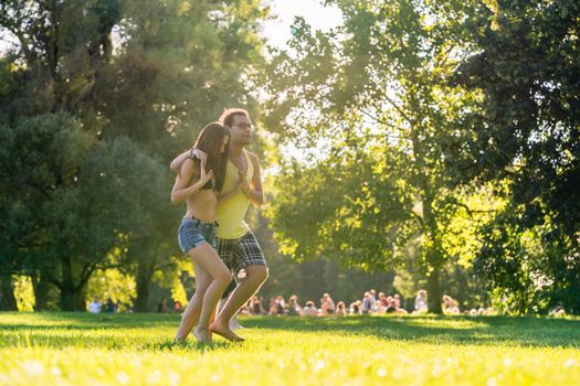 Woman and man dancing in park outdoors