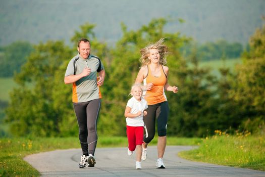 Family jogging outdoors with the kids