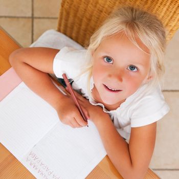 Children doing homework for school together helping each other