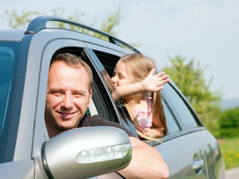 Family with kids in a car