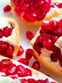 Top view closeup image of red pomegranate seeds on pomegranate seeds pile present a detail of pomegranate seeds texture, fruit background, red background