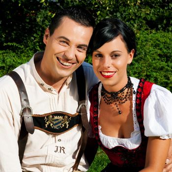 Couple- man and woman - in traditional Bavarian dress, Lederhosen and Dirndl