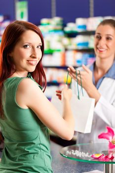 Female pharmacist with a female customer in her pharmacy