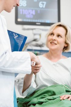 Doctor shaking hands of woman patient recovering after operation in hospital