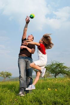 Family affairs - father and daughter playing football together