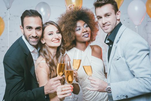 Group of party people celebrating with drinks a birthday or New years eve party