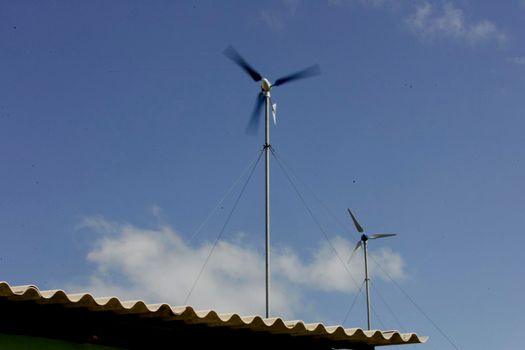 nova vicosa, bahia / brazil - setembro 8, 2009: small wind turbine used in a project to collect electricity for the community of Ilha da Cassumba, in Nova Vicosa.