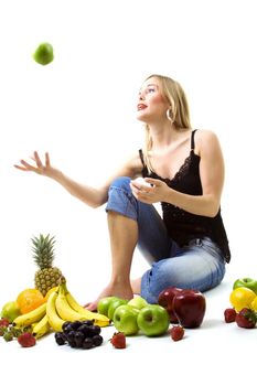 Food, fruit and healthy nutrition - Blond girl catching a green apple