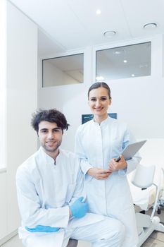 Doctor woman and man with tablet computer in their practice working in a modern environment