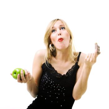 Woman eating candy instead of fresh apple