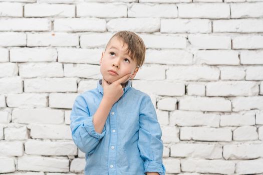 Pensive student boy thinking hard