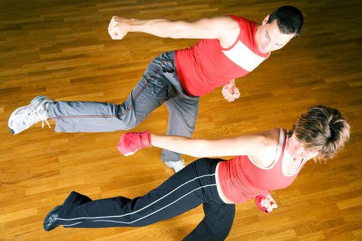 Couple practicing martial art moves in a sparring