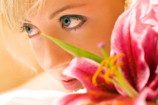 Girl with flowers in a spa situation feeling visibly good