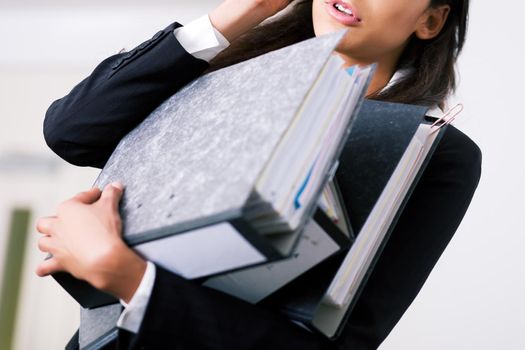 Woman in a office (just torso) doing different things at the same time