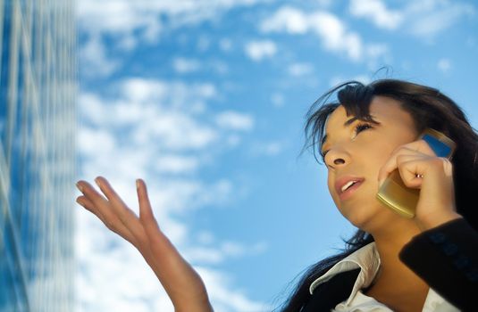 Brunette woman using her phone, gesturing