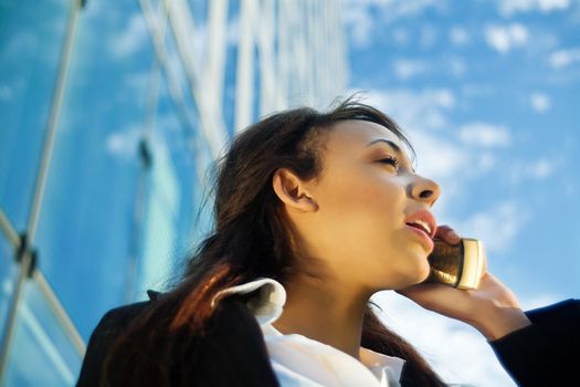 Young female professional using phone outside her office
