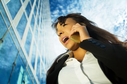 A young brunette professional using her cell phone, shouting at it or receiving not so good news