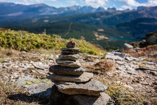 Stone pyramid marking hiking path in the mountains