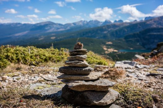 Stone pyramid marking hiking path in the mountains