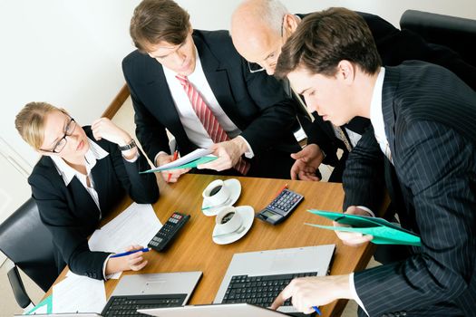 Businesspeople crunching the numbers of a business plan