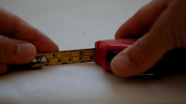 salvador, bahia / brazil - july 10, 2020: hand holds measuring tape with measuring scale in the city of salvador.