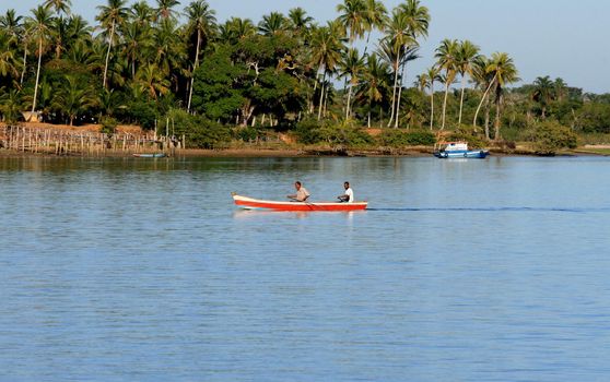 caravelas, bahia / brazil - september 11, 2008: people are seen in a rowboat in the waters of the Caravalas river in the city of Caravelas in southern Bahia.