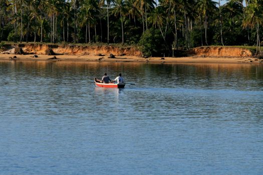 caravelas, bahia / brazil - september 11, 2008: people are seen in a rowboat in the waters of the Caravalas river in the city of Caravelas in southern Bahia.