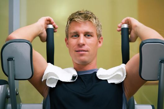 Man working out in the Gym on a machine