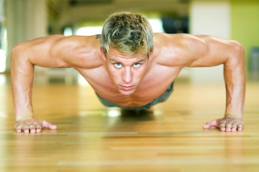 Strong, handsome man doing push-ups