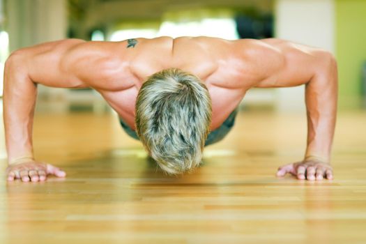 Strong, handsome man doing push-ups